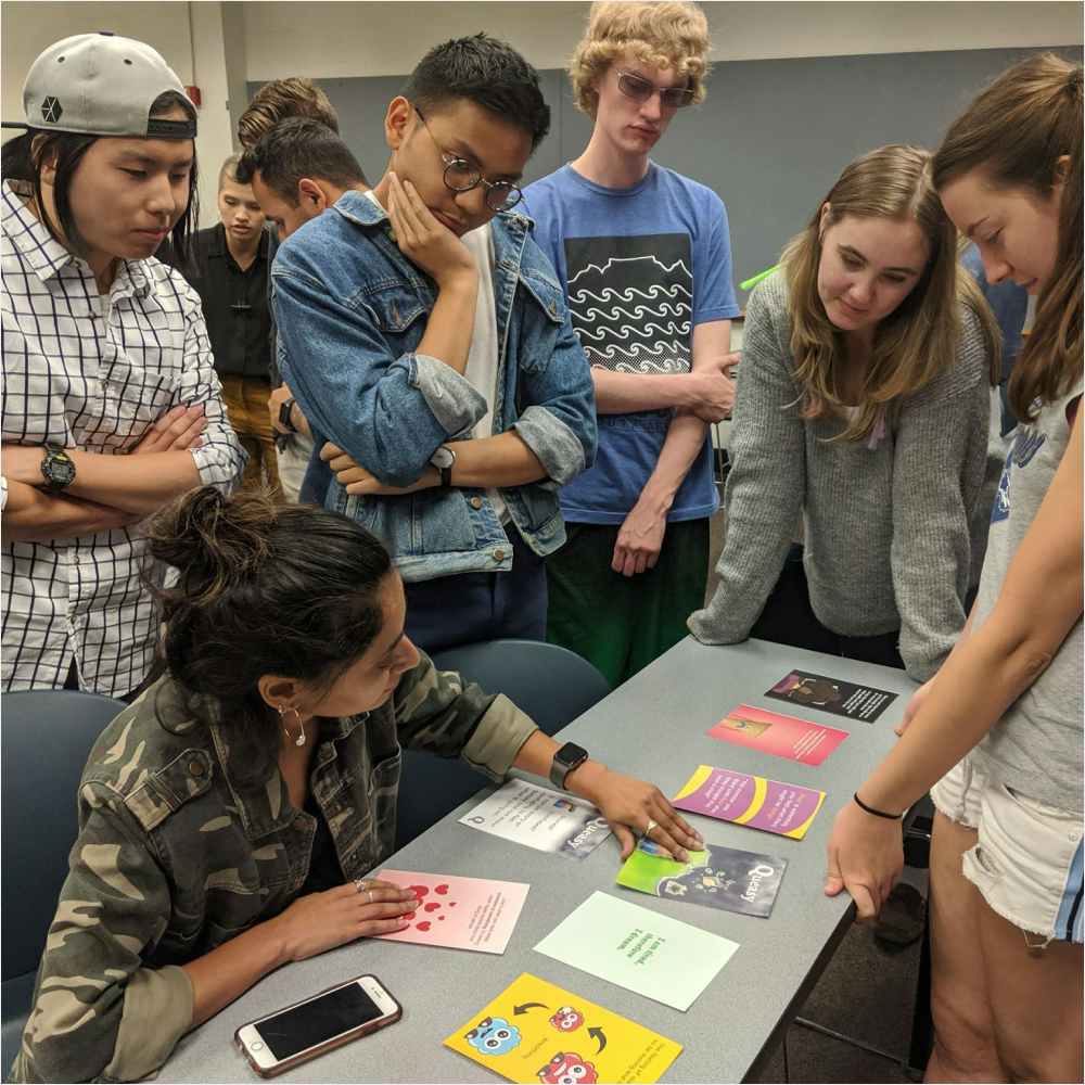 Team reviewing printed cards during creation process Team reviewing printed cards during creation process