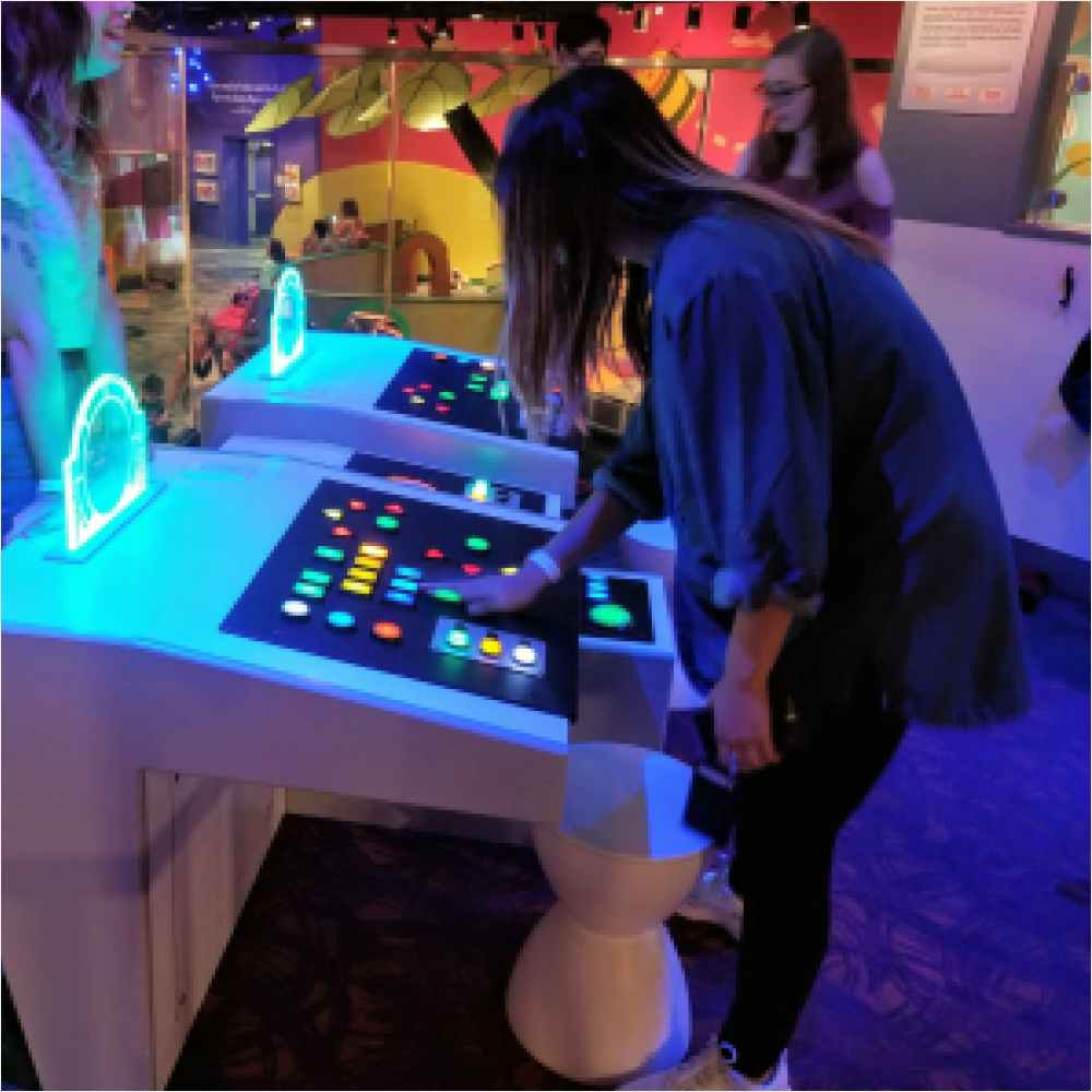 Girl using spaceship control panel at Strong Museum of Play