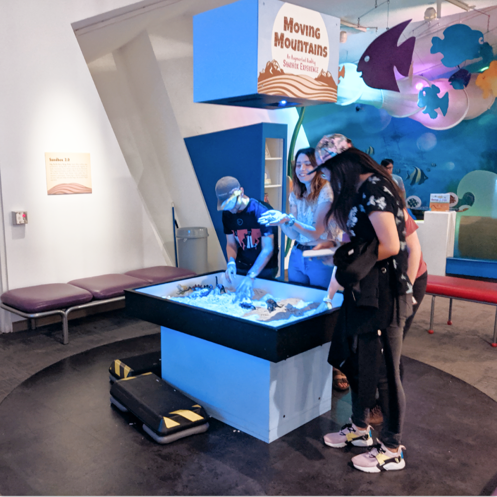 Students examining interactive digital exhibit
