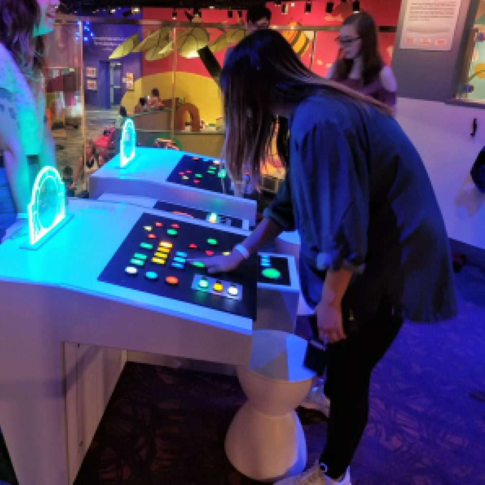 Girl using spaceship control panel at Strong Museum of Play